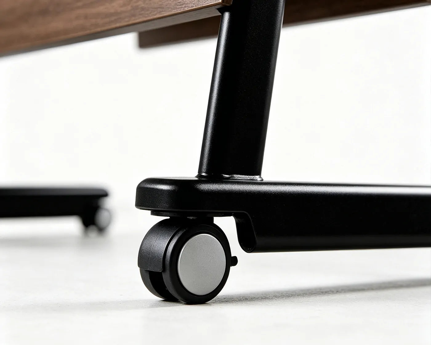 Close-up of heavy-duty lockable casters on mobile training table